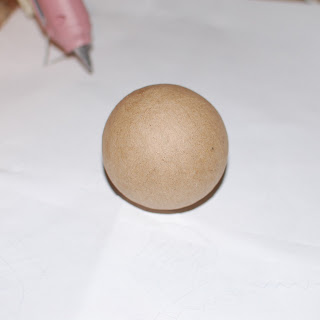 Foam craft ball with colorful scrap yarn and a hot glue gun