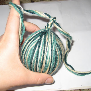 Finished yarn ball ornament ready for a yarn bow or hanging loop