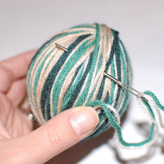 Several colorful yarn strands gathered for the decorative wrap
