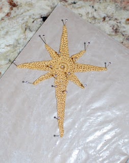 Crochet Star of Bethlehem pinned into shape for blocking