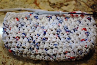 Reusable crochet grocery tote made with upcycled plastic bag yarn