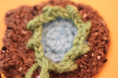 Eight chain spaces attached evenly around the back of the crochet owl