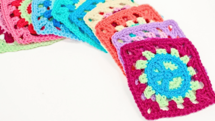 Crochet peace sign granny square worked in three colors