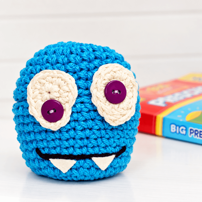 Two-eyed blue monster crochet apple cozy