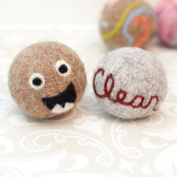 Needle felted designs on laundry balls