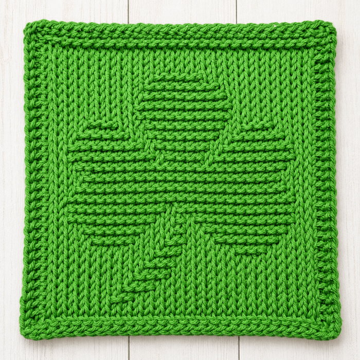 Green Tunisian crochet dishcloth with a shamrock design