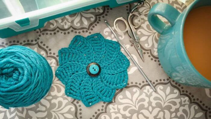 This gorgeous swirl flower crochet pattern is sure to make a statement ... try working it up in different yarn weights and use it to embellish just about anything!