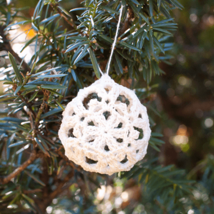 Crochet lace bauble hanging on Christmas tree