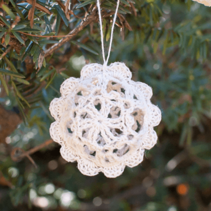 Round crochet lace bauble with scalloped edging