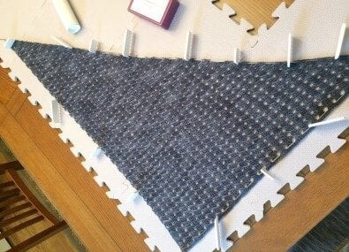Any Season crochet shawlette showing its asymmetrical triangular shape